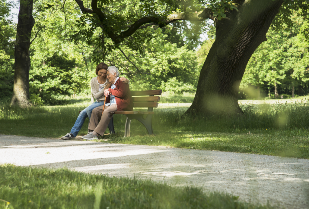 Senior woman sitting on park bench with granddaugh 2025 04 04 20 53 06 utc