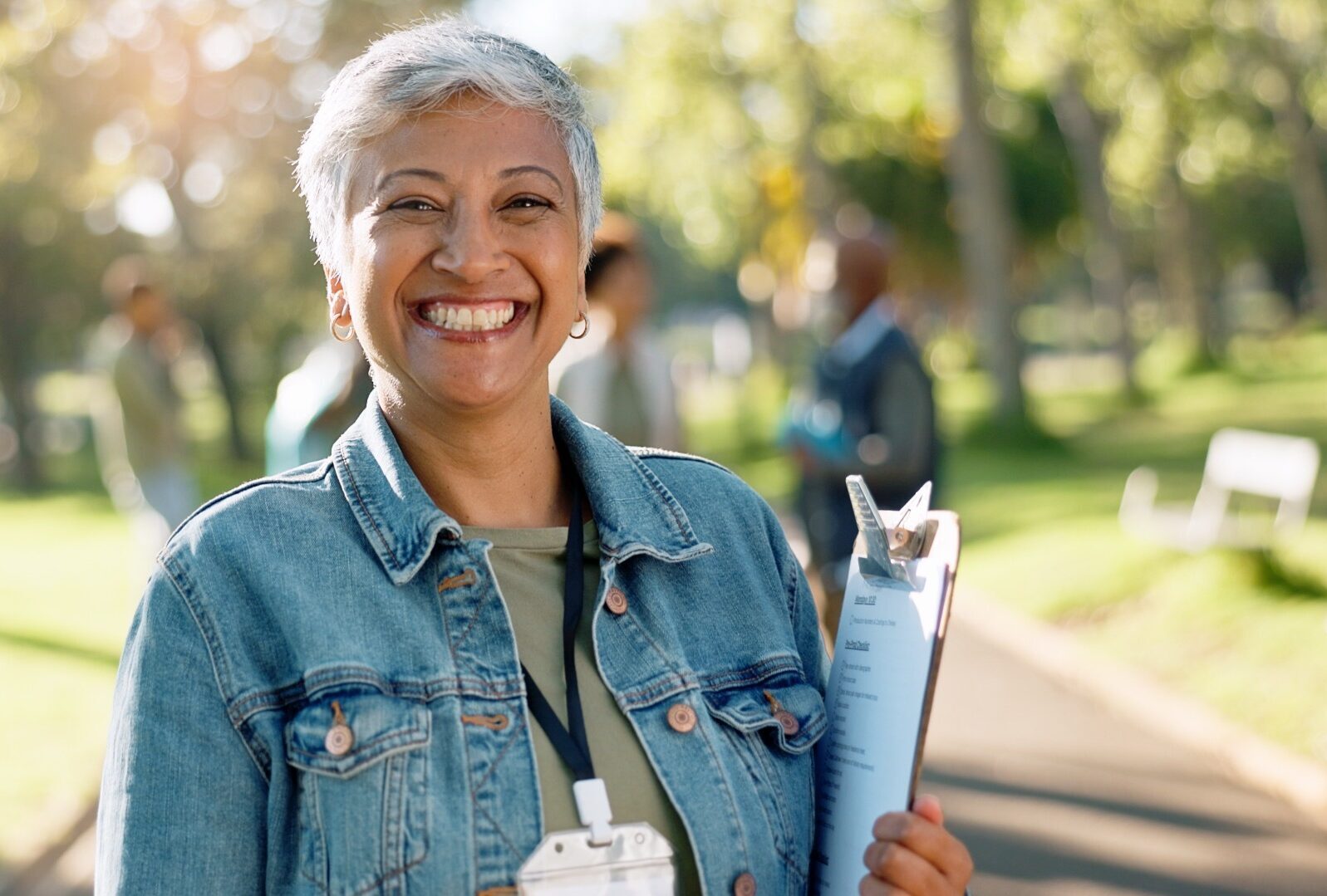 Smiling volunteer with short gray hair wearing a denim jacket